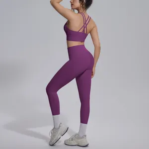 Detailed view of plum cross-back sports bra and high-waisted yoga leggings set