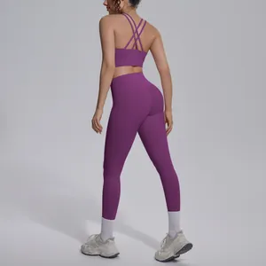 Back view of purple yoga set featuring cross strap sports bra and high waisted leggings