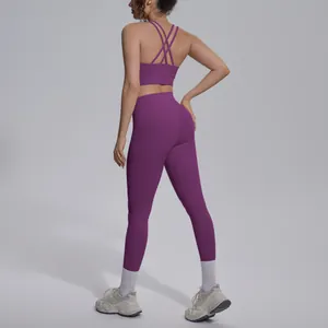 Back view of purple yoga set featuring cross back sports bra and high waist leggings