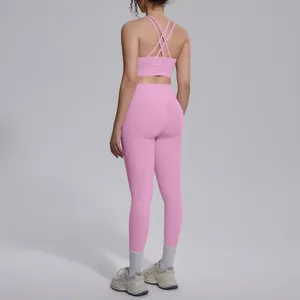 Back view of pink yoga set with criss-cross sports bra and high-waisted leggings