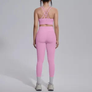 Rear view of pink sports bra with criss-cross straps and matching high-waisted leggings
