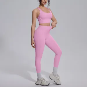 Close-up of pink high-waist yoga leggings and sports bra set showing elastic fit