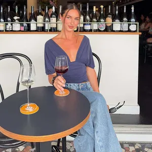 Fashionable blue deep V-neck short-sleeved top presented in a casual lifestyle setting