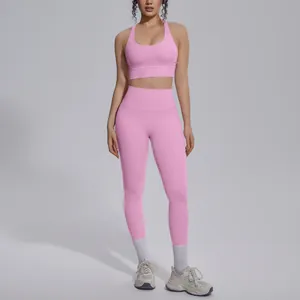 Full body view of a pink high-waisted yoga set with a sports bra and leggings