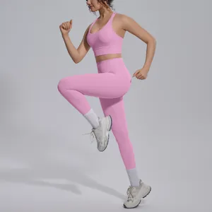 Detail view of pink sports bra and high-waisted yoga leggings set on running model