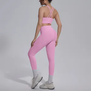 Detailed back view of pink cross-strap sports bra and high-waisted yoga leggings set