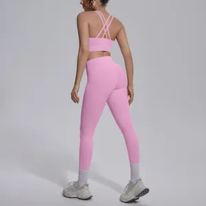 Back view detail of pink cross-back sports bra and high-waisted yoga leggings set.
