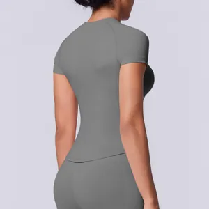 Vista posteriore di una t-shirt da yoga grigia senza cuciture, elastica e aderente