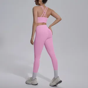 Detailed back view of pink criss-cross sports bra and high-waisted yoga leggings set.