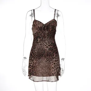 Front view of a sexy leopard print chiffon mini dress displayed on a clear mannequin stand