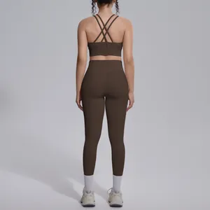 Back view of a premium brown criss-cross sports bra and high-waisted leggings set for yoga