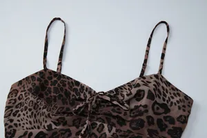 Detail of sexy leopard print chiffon camisole dress featuring tie-front and V-neckline