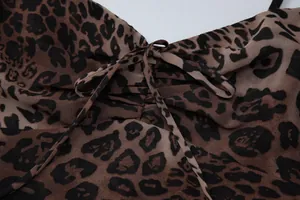 Close-up of leopard print chiffon dress with adjustable drawstring V-neck details