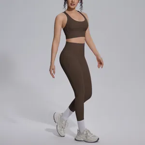Detail of brown nylon yoga set showing cross back bra and high-waist leggings.