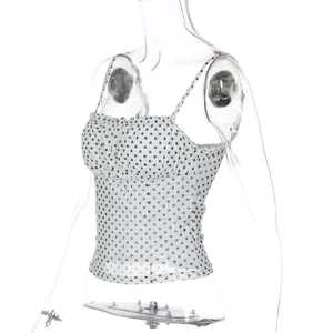 Detailed side view of a white polka dot camisole top featuring slim straps and ruffled bust