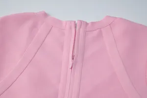 Close-up detail of the high-quality invisible zipper on the back of a pink bandage dress