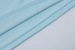 Close-up detail of light blue high-elastic fabric featuring professional flatlock stitching.