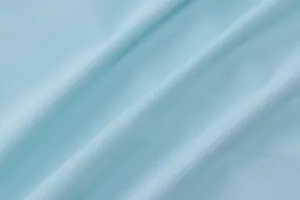 Close-up detail of the light blue ribbed knit fabric texture for women's fashion top