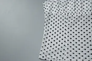 Macro view showing the mesh texture and polka dot print of the slim fit camisole top