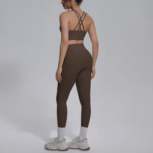 Detailed back view of a chocolate brown cross-back sports bra and matching high-waist leggings
