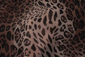 Detailed close-up of leopard print chiffon fabric showing lightweight texture and soft drape
