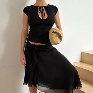 Close-up detail of a black short-sleeve top featuring a sexy keyhole cutout and tie-neck design
