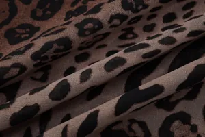 Macro view showing the soft folds and leopard print pattern of the chiffon dress fabric