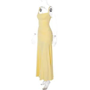 Side view of a pale yellow sleeveless long evening dress with elegant ruching details