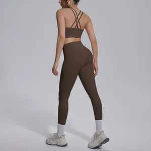 Back view of brown sports bra and leggings yoga set showing elegant cross-back detail