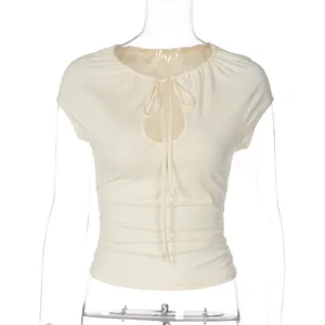 Front view detail of ruched cream t-shirt with tie-neck and cutout