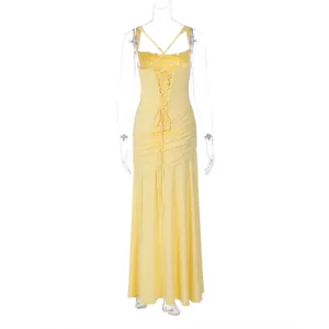 Back view of yellow sleeveless evening gown showing intricate lace-up corset detail