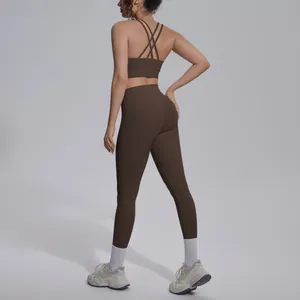 Detailed view of the brown cross-back sports bra and leggings yoga set on model