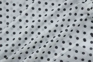 Detail view showing the fine mesh texture and black polka dot print of the camisole