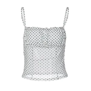 Close-up of white polka dot mesh camisole with ruffled neckline and thin straps