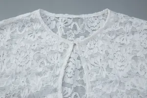 Close-up of elegant white floral lace pattern with subtle sequin details