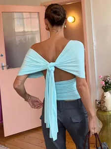 Elegant aqua blue backless shawl style top with a large bow tie for summer fashion wear.