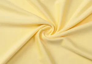 Close-up of soft yellow knit fabric texture showing fine weave details for evening dress