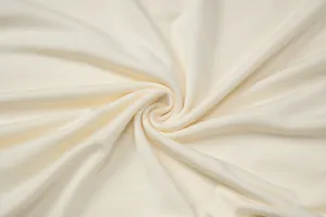Detailed macro shot of soft cream-colored jersey fabric texture for women's T-shirt