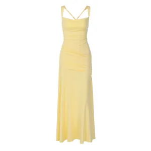 Detail view of a yellow sleeveless evening dress with ruched body and criss-cross back straps