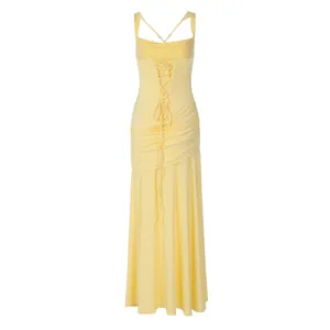 Detailed back view of a slim yellow evening gown with elegant lace-up and cross-strap design.