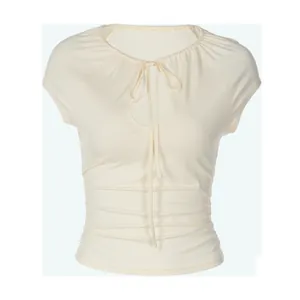 Close-up of cream hollow-out neckline T-shirt with tie-up detail and shirred waist
