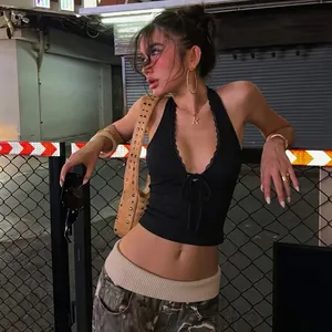 Detailed view of a sexy black lace halter crop top in an urban street setting