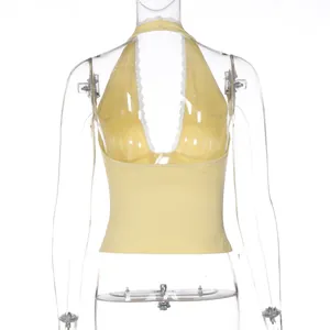 Detail view of the back of a yellow halter top with delicate white lace trim details.
