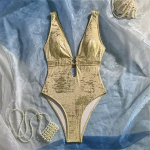 Close-up of gold foil metallic one-piece swimsuit featuring deep V-neck and ring