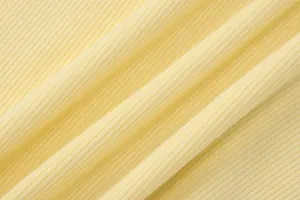 Macro close-up showing the soft pale yellow ribbed knit fabric texture of the halter top