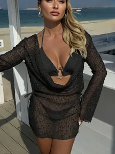Detail of black sequin mesh cover-up and bikini with gold ring detail