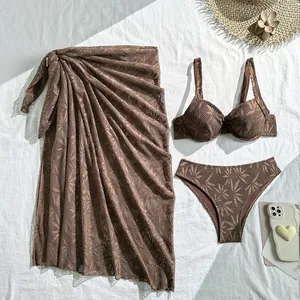 Detailed view of brown lace three-piece bikini set with matching beach sarong skirt