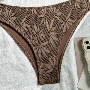 Detailed view of brown crochet lace bikini bottom featuring intricate leaf patterns