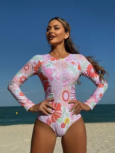 Floral long sleeve one piece swimsuit with front zipper on sunny beach background