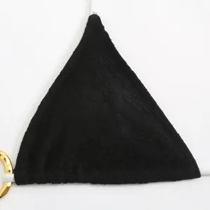 Detailed macro view of black lace and mesh triangle bikini cup with gold ring accent